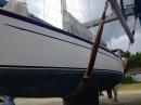New hull paint: Thalia in a sling on a travel lift, ready to be moved back into the water.